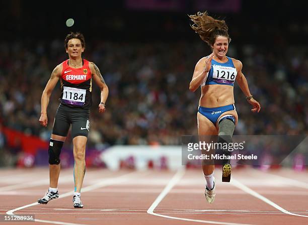 Martina Caironi of Italy crosses the line to win gold ahead of bronze medallist Jana Schmidt of Germany in the Women's 100m T42 Final on day 7 of the...