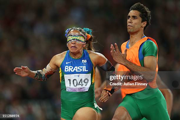 Terezinha Guilhermina of Brazil and guide Guilherme Soares de Santana cross the line to win gold in the Women's 100m T11 Final on day 7 of the London...