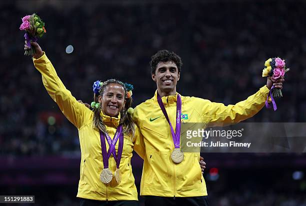 Gold medallists Terezinha Guilhermina of Brazil and guide Guilherme Soares de Santana pose on the podium during the medal ceremony for the Women's...