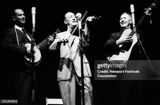 Traditional old-timey musicians Kirk McGee, fiddler Arthur Smith, and Sam McGee perform at the Newport Folk Festival in July 1965 in Newport, Rhode...