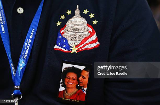 Person wears a pin of First lady Michelle Obama and Democratic presidential candidate, U.S. President Barack Obama during day two of the Democratic...