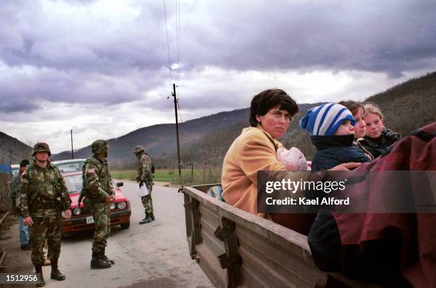 Albanian refugees from the Presevo valley pass through an American checkpoint November 26, 2000 on the boundary of Kosovo. Approximately 1200...