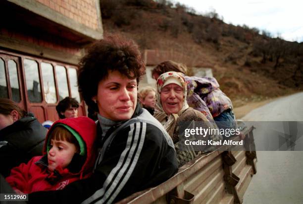 Albanian refugees from the Presevo valley pass through an American checkpoint November 26, 2000 on the boundary of Kosovo. Approximately 1200...