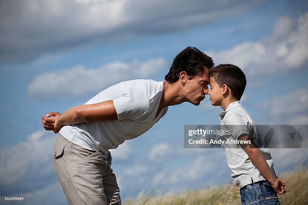 Father and son in a field showing affection