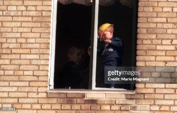 Actor Tony Randall's child gets dangerously close to an open window November 23, 2000 while watching the Macy's Thanksgiving Day Parade in New York...
