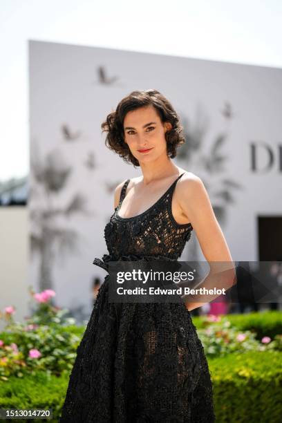 Nine d'Urso wears a black lace cut-out pattern tank-top midi dress from Dior, outside Dior , during the Haute Couture Fall/Winter 2023/2024 as part...