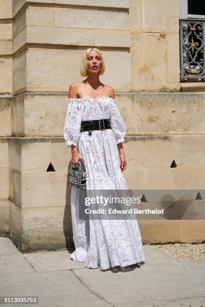 Maria Olympia de Grece wears a white with lace cut-out pattern shoulder-off / puffy long sleeves / long ruffled dress from Dior, a black large Saddle...