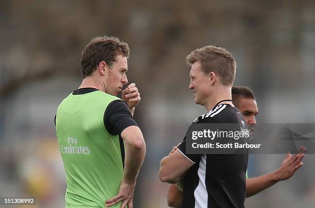 Nick Maxwell of the Magpies talks with Nathan Buckley, coach of the Magpies during a Collingwood Magpies AFL training session at Gosch's Paddock on...