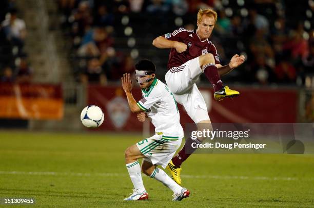 Jeff Larentowicz of the Colorado Rapids turns the ball away from Kosuke Kimura of the Portland Timbers at Dick's Sporting Goods Park on September 5,...
