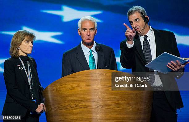 Former Florida Republican Governor Charlie Crist, center, previews the podium set up and teleprompters on stage before his speech to the Democratic...
