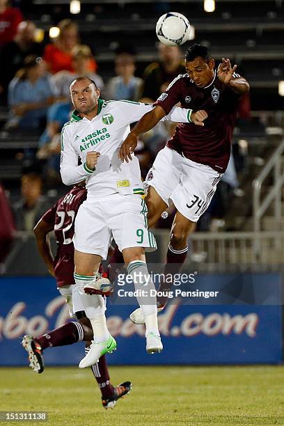 Kris Boyd of the Portland Timbers and Tyrone Marshall of the Colorado Rapids battle for a head ball at Dick's Sporting Goods Park on September 5,...