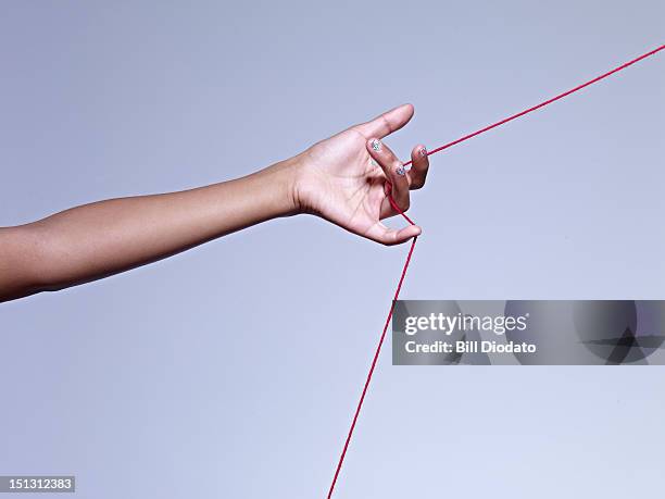 Hand String Fotografías e imágenes de stock - Getty Images