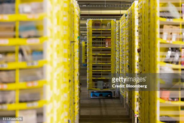 Robot transports a pallet of items to employees for sorting at the Amazon.com Inc. LCY3 fulfillment center in Dartford, UK, on Friday, July 7, 2023....