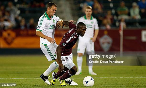 Hendry Thomas of Colorado Rapids controls the ball against Jack Jewsbury of Portland Timbers at Dick's Sporting Goods Park on September 5, 2012 in...