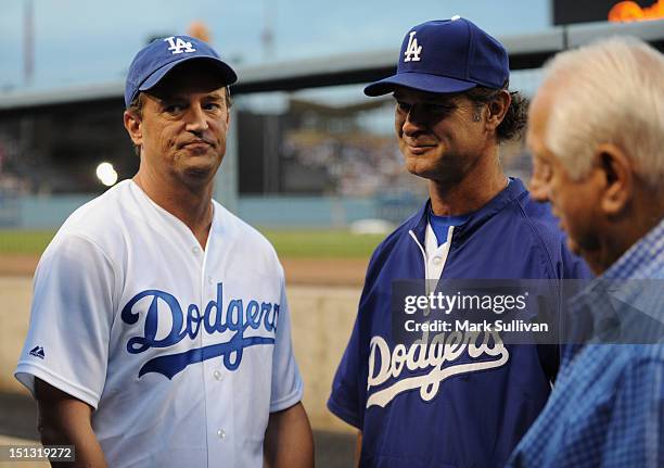 Actor Matthew Perry meets Dodger manager Don Mattingly and former Dodger manager Tommy Lasorda in the Dodger dugout before the game at Dodger Stadium...