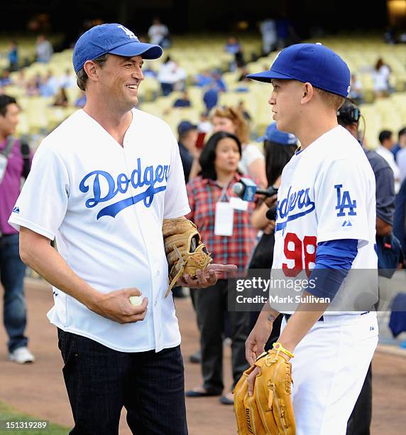 Actor Matthew Perry talks with Dodger bat boy Eddie Gonshorowski at Dodger Stadium on September 5, 2012 in Los Angeles, California.
