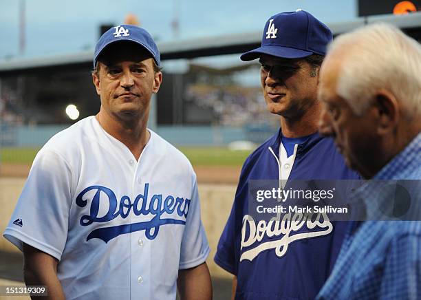 Actor Matthew Perry meets Dodger manager Don Mattingly and former Dodger manager Tommy Lasorda in the Dodger dugout before the game at Dodger Stadium...