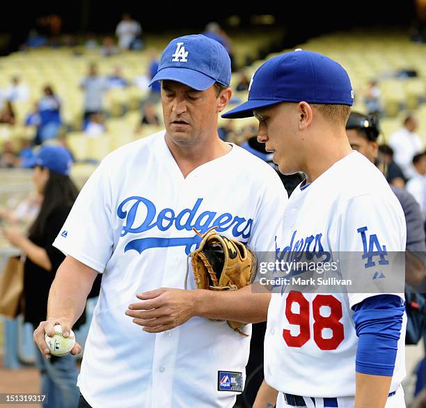 Actor Matthew Perry talks with Dodger bat boy Eddie Gonshorowski at Dodger Stadium on September 5, 2012 in Los Angeles, California.