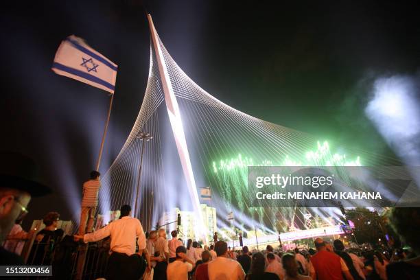 Israelis participate in the inauguration ceremony of the 'Chords Bridge' , designed by Spanish architect Santiago Calatrava, at the main entrance of...