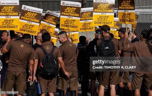 United Parcel Services workers walk a 'practice picket line' on July 7 in the Queens borough of New York City, ahead of a possible UPS strike. UPS...