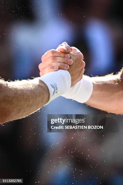 Greece's Stefanos Tsitsipas shakes hands with Britain's Andy Murray after winning their men's singles tennis match on the fifth day of the 2023...