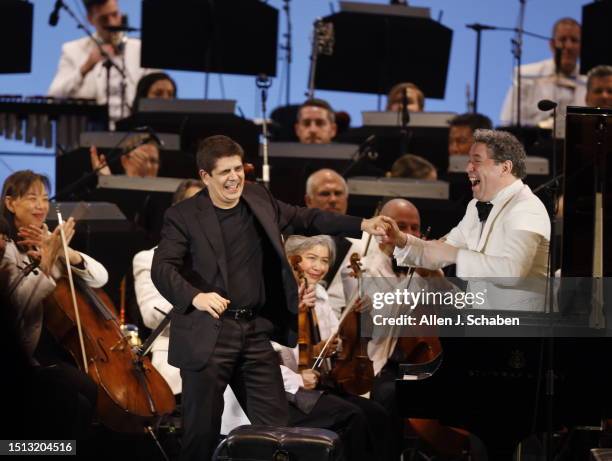 Hollywood, CA Javier Perianes, left, who soloed on piano, takes a bow with Gustavo Dudamel after conducting the Los Angeles Philharmonic, performing...