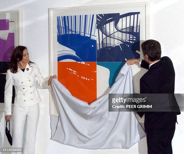 Danish Crown Prince Frederik and Princess Mary unveil a painting by Danish artist Olafur Eliasson during a function at the Danish embassy in Berlin...