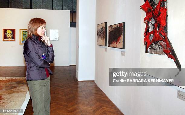 Woman looks at a picture by Austrian actionist artist 78 year-old Otto Muehl, that form part of the largest exhibition yet of his work, 03 March 2004...