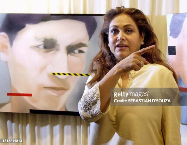 Tina Ambani, wife of the vice Chairman of Reliance Industries Anil Ambani, stands in front of a painting forming the "Eight Harmony Show 2003" at a...