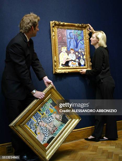 Curators prepare to hang two paintings by Henri Matisse in at Christies in London, 18 June 2004. The painting on the left is entitled "Odalisque au...