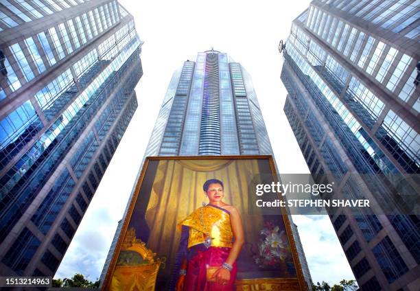 Large potrait of Queen Sirikit stands in front of one of Bangkok's newest and most modern plazas, 08 August 2002, several days before her birthday...