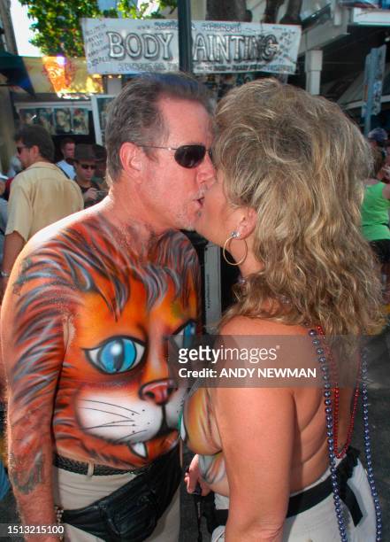 Painted couple kiss prior to the Fantasy Fest Parade 26 October 2002 in Key West, Florida. The parade is the highlight event of the 10-day masking...