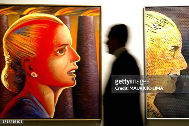 Visitor looks at a painting portraying former Argentine First Lady Eva Perón , better known as Evita, 13 November, 2002 at a show called "Evita:...