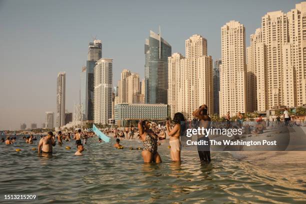 Beachgoers at JBR Beach in the Dubai Marina on July 01, 2023 in Dubai United Arab Emirates.