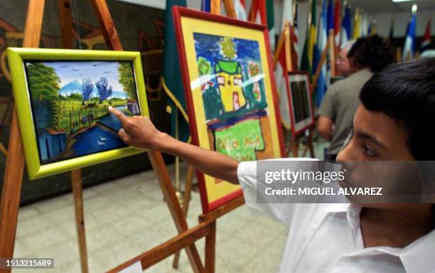 Year-old Neryn Manuel Rivera Aguilar explains with the aid of a painting how he lost his right leg to an anti-personnel mine as he was tending to...