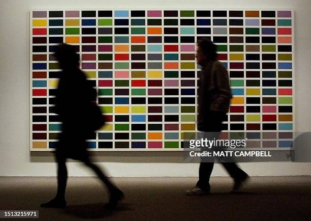 Members of the media walk past a work entitled "256 Colors [256 Farben]" by German artist Gerhard Richter at the press preview for the opening of the...