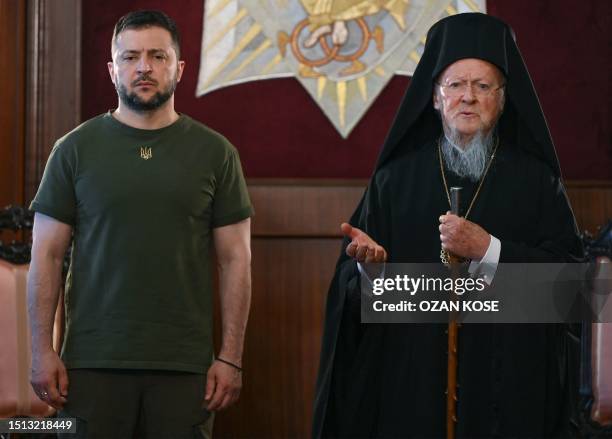 Ecumenical Patriarch Bartholomew I gestures next to Ukraine's President Volodymyr Zelensky as they attend a joint press conference at the Patriarchal...