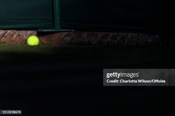 Tennis ball lies at the edge of a court during day four of The Championships Wimbledon 2023 at All England Lawn Tennis and Croquet Club on July 6,...