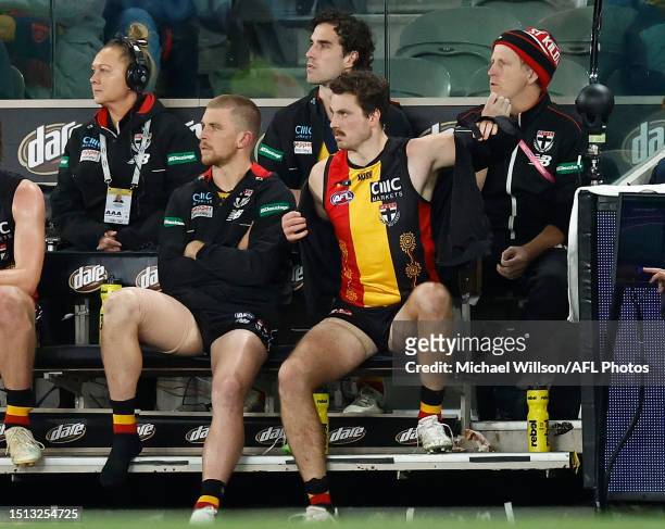 Sebastian Ross, Max King and Zaine Cordy of the Saints look on from the bench after being subbed from the match during the 2023 AFL Round 17 match...