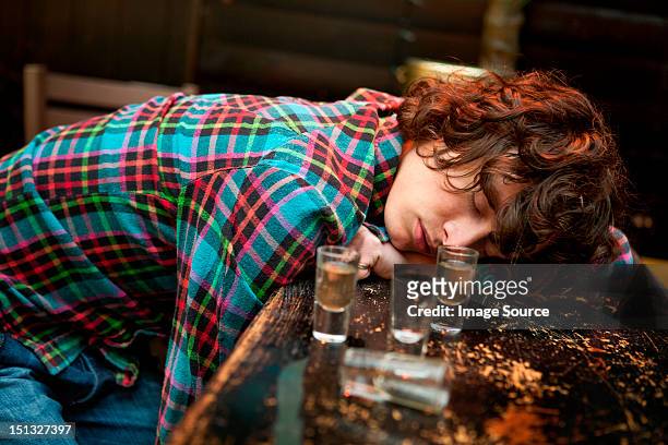 drunk man slumped on bar asleep - drinken stock pictures, royalty-free photos & images