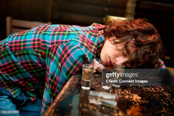 drunk man slumped on bar asleep - plakat bildbanksfoton och bilder