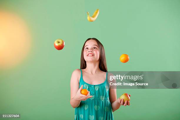 girl juggling fruit - juggling stock pictures, royalty-free photos & images