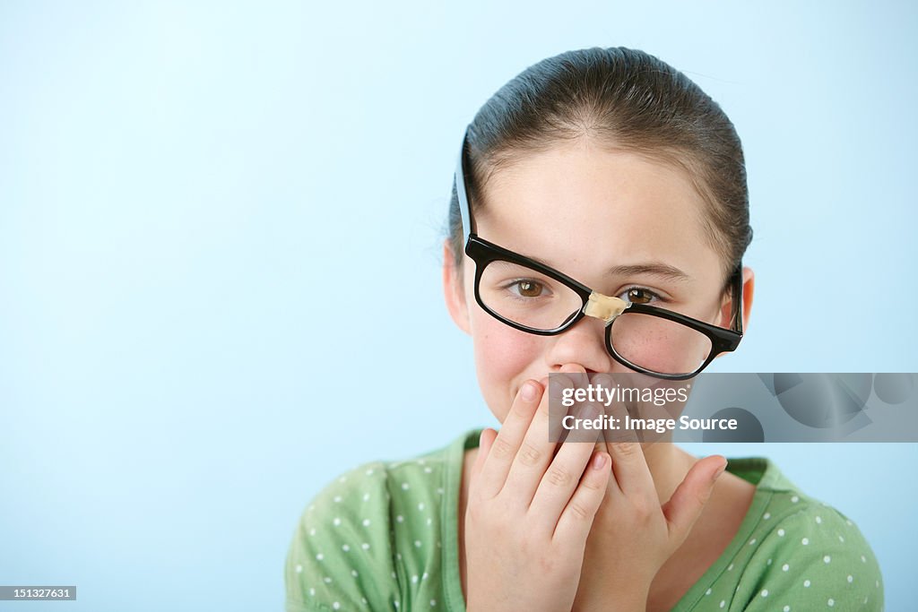Girl wearing broken glasses