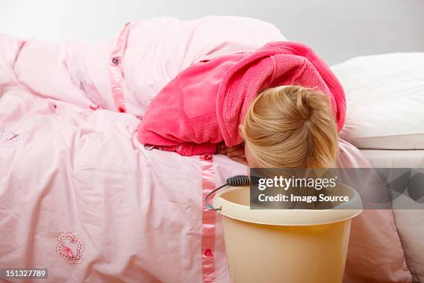 sick girl with bucket - vomit stock pictures, royalty-free photos & images