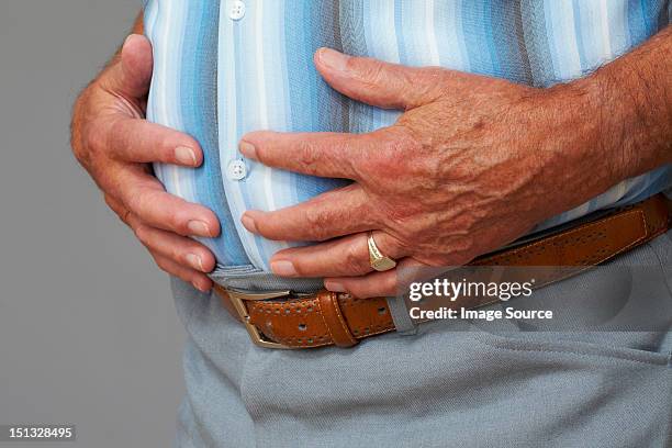 overweight senior man touching stomach - belly ring 個照片及圖片檔
