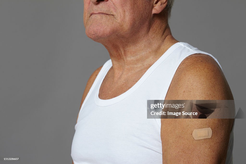 Senior man with plaster on arm