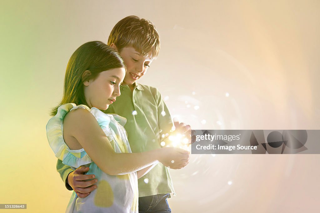Girl and boy holding lights