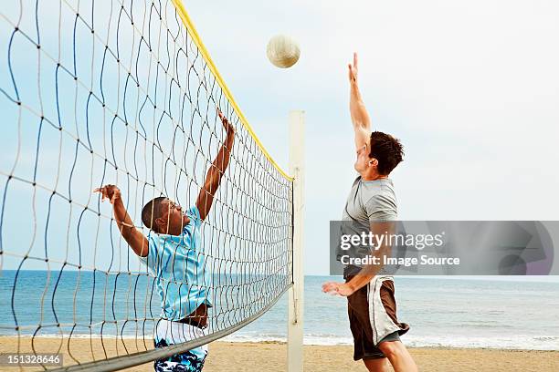 two young men playing beach volleyball - young men photos stock pictures, royalty-free photos & images