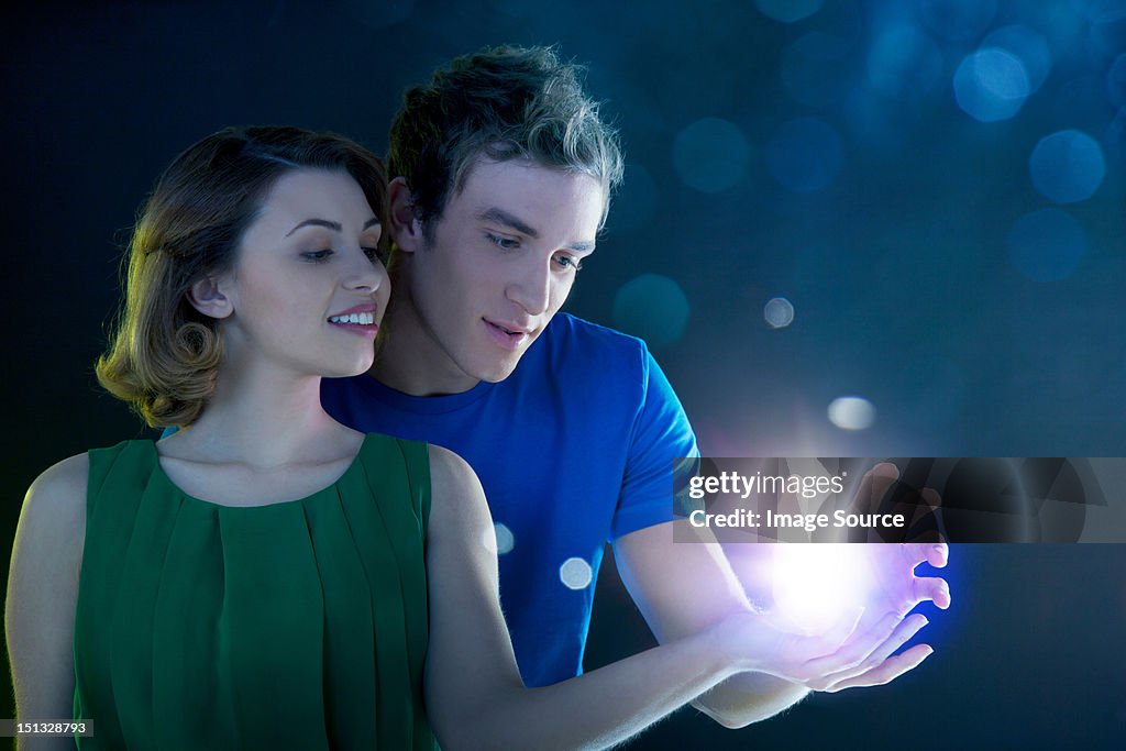 Young couple holding light