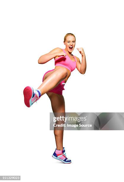 young woman kicking out - schoppen lichaamsbeweging stockfoto's en -beelden